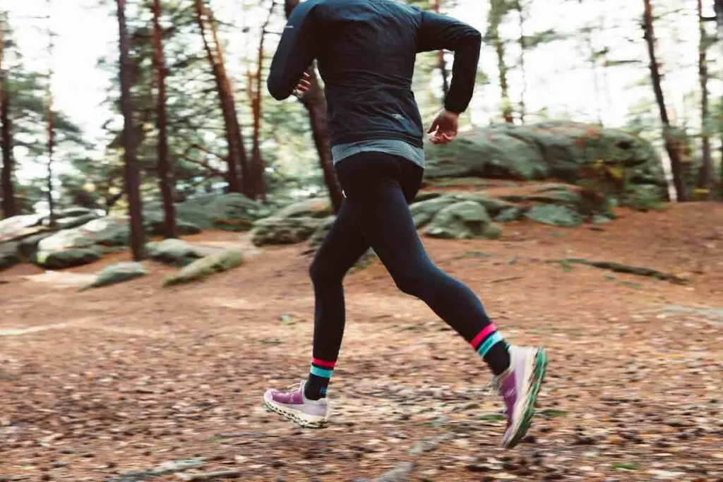 Running on a woodland path surrounded by trees