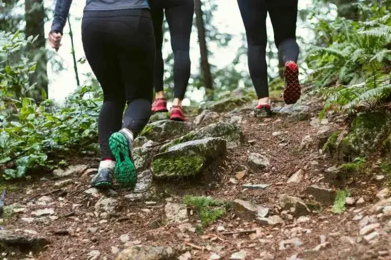 A group of women running in trail shoes