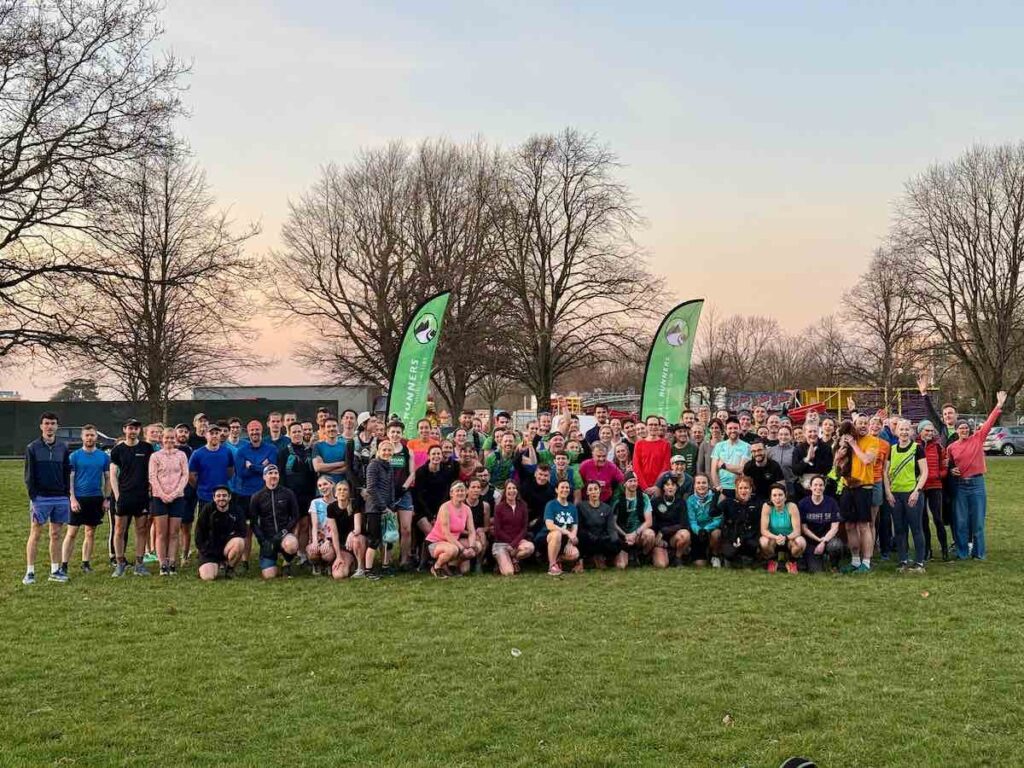 Group shot of The Green Runners run club in a field