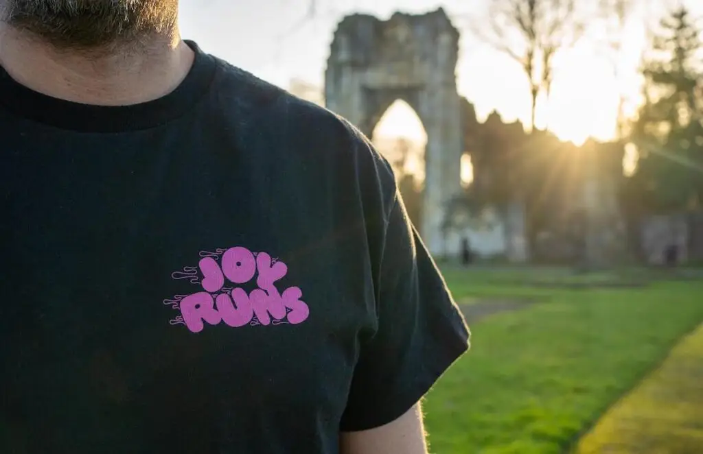 Joy Runs t-shirt - front on outdoors