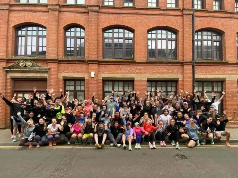 100 runners from Brighton's Lanes Run Club waving for a group shot outside