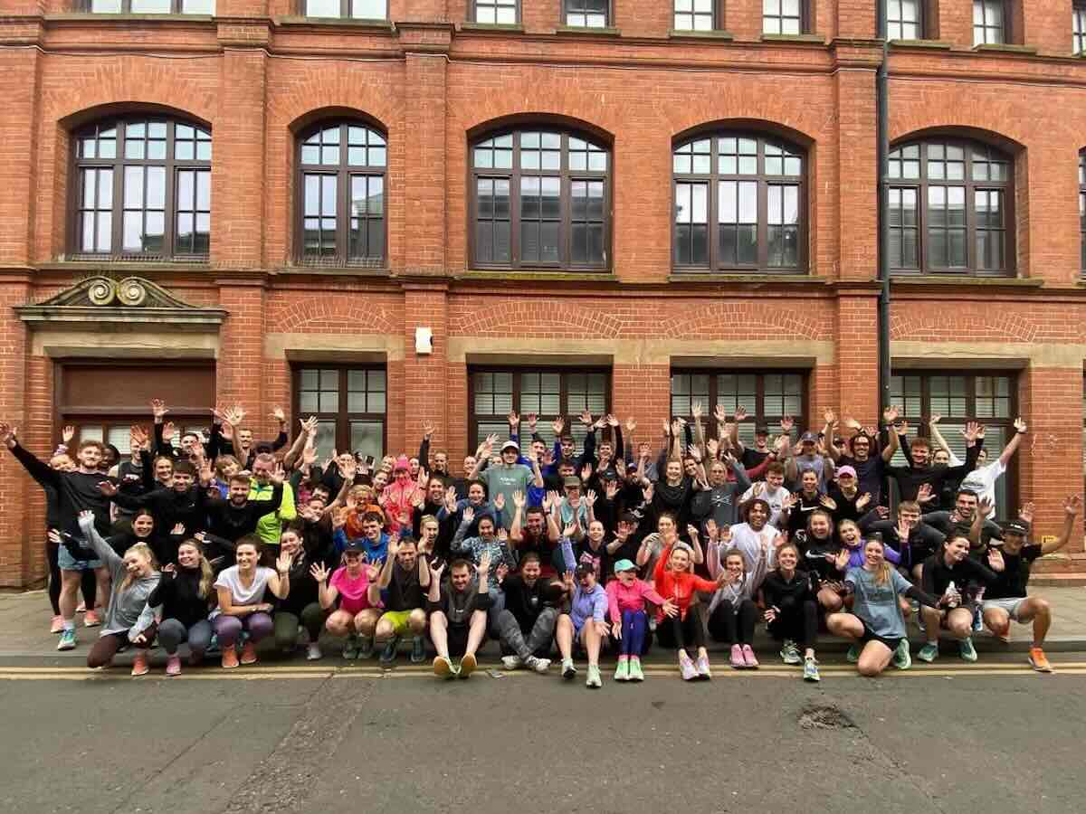 100 runners from Brighton's Lanes Run Club waving for a group shot outside
