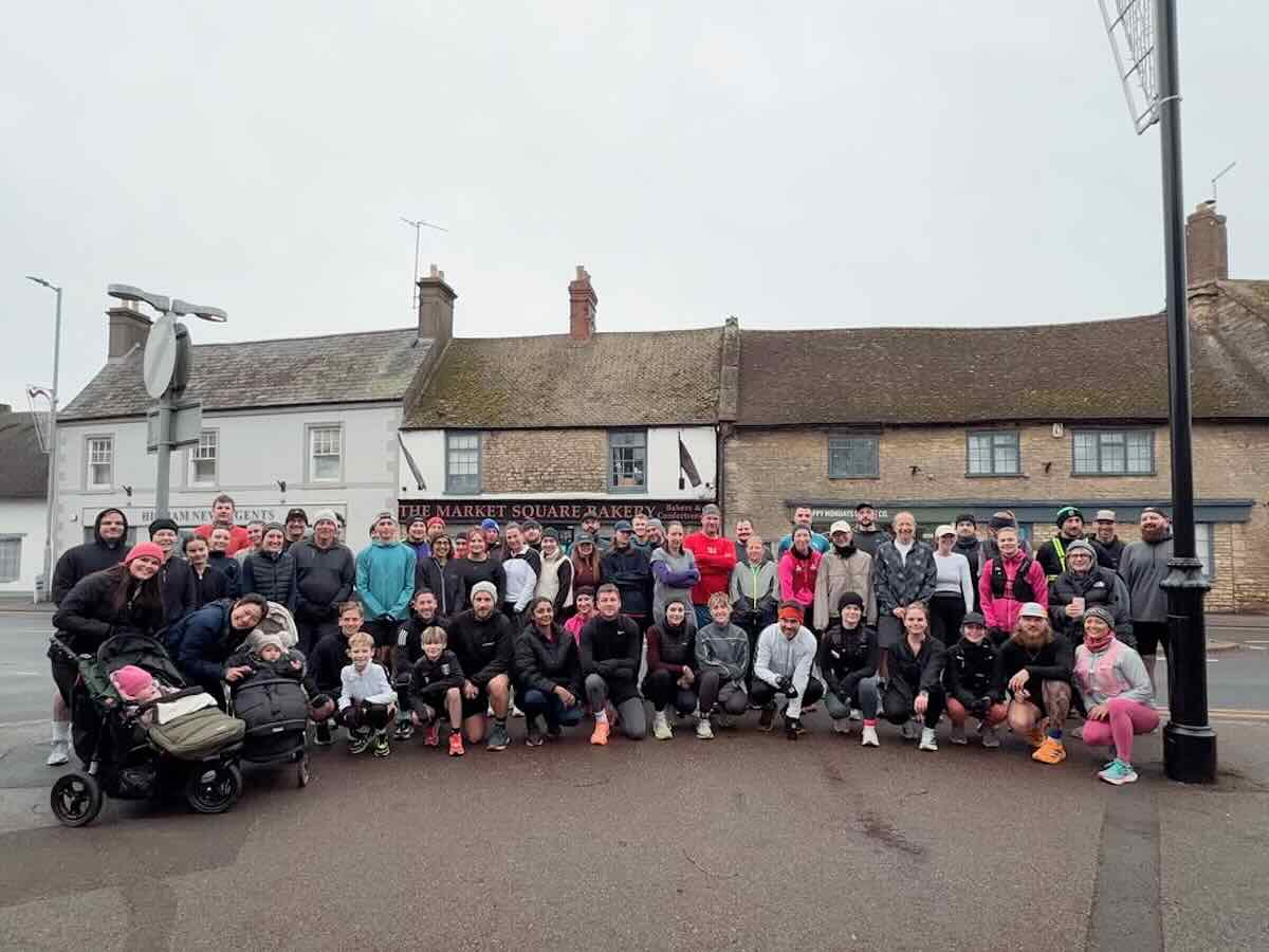 Group photo of Broken Society Run Club in front of Northamptonshire high street